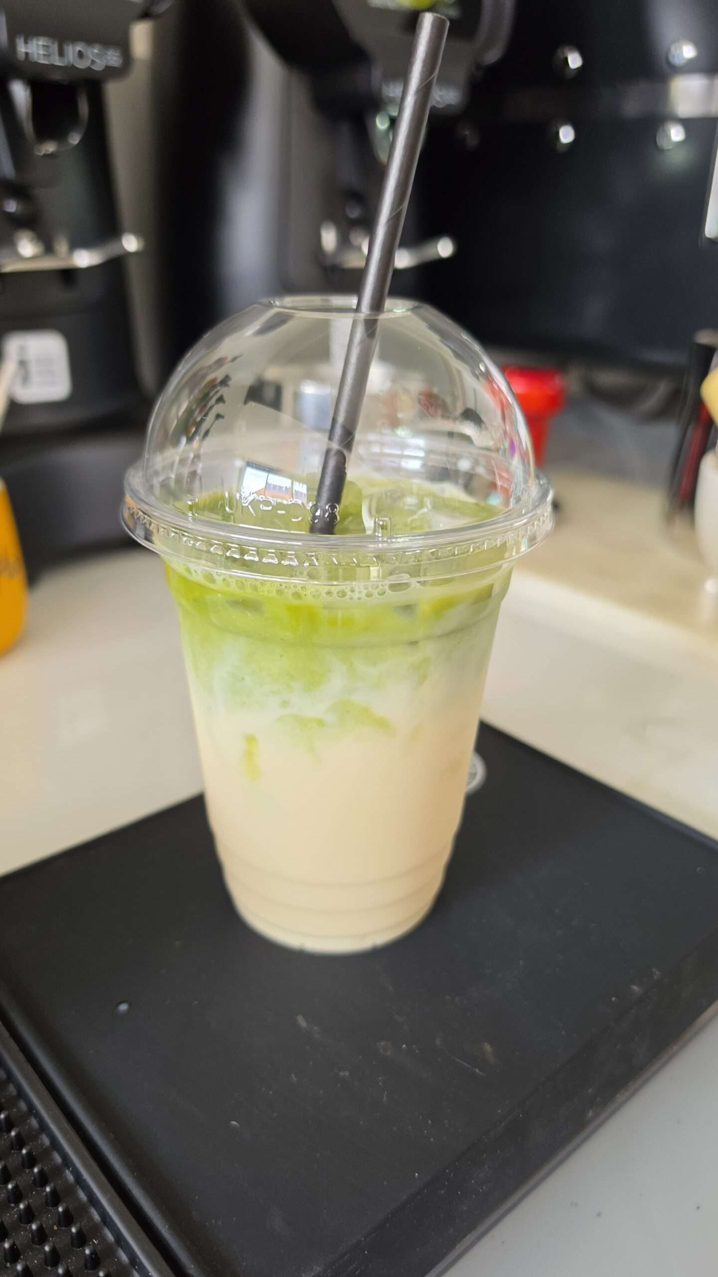 Iced matcha latte served in a takeaway cup at Coffee with Flo.